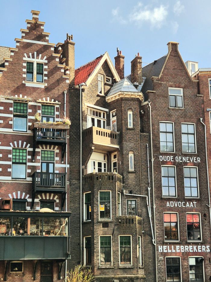 Charming historic brick buildings in Amsterdam with classic gables and intricate architecture.
